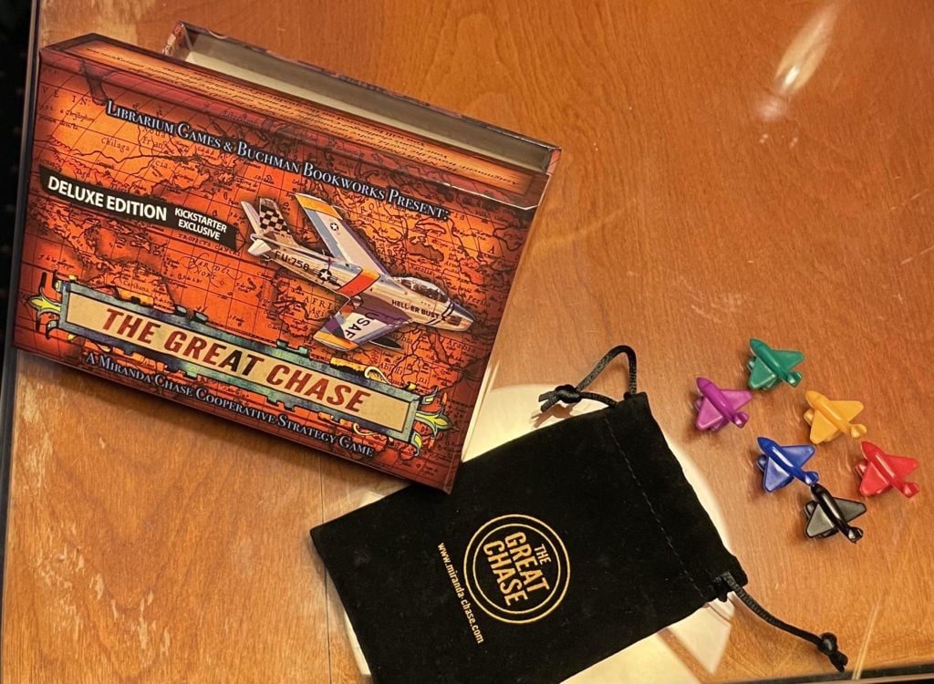 This image shows the production prototype box artwork for the "Kickstarter Exclusive" reward. It also features a felt bag with the game logo as well as six small airplane pieces that are also part of the upgraded kit.